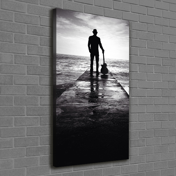 Verticaal schilderij op canvas Gitarist op de pier