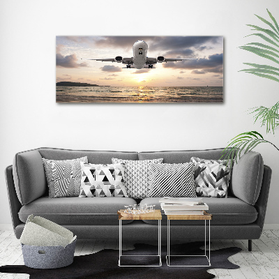 Foto schilderij op glas Een vliegtuig boven de zee