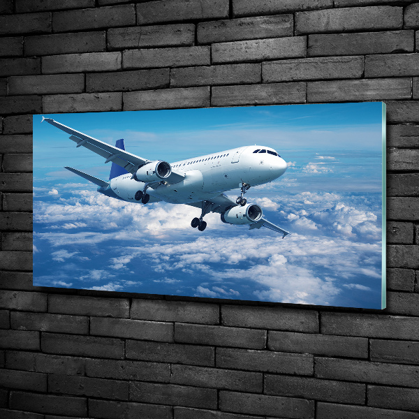 Foto schilderij op glas Een vliegtuig in de wolken