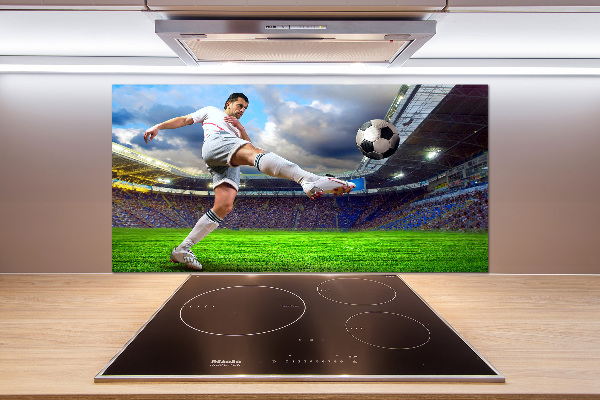 Glazen achterwand keuken Een voetballer in het stadion.
