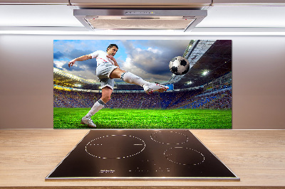 Glazen achterwand keuken Een voetballer in het stadion.