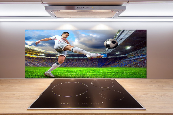 Glazen achterwand keuken Een voetballer in het stadion.