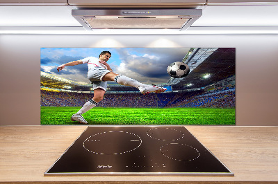 Glazen achterwand keuken Een voetballer in het stadion.