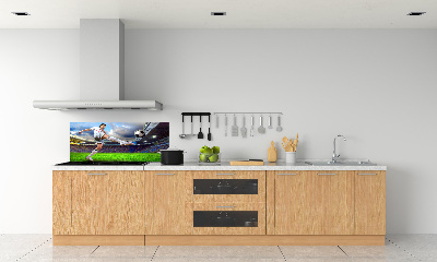 Glazen achterwand keuken Een voetballer in het stadion.