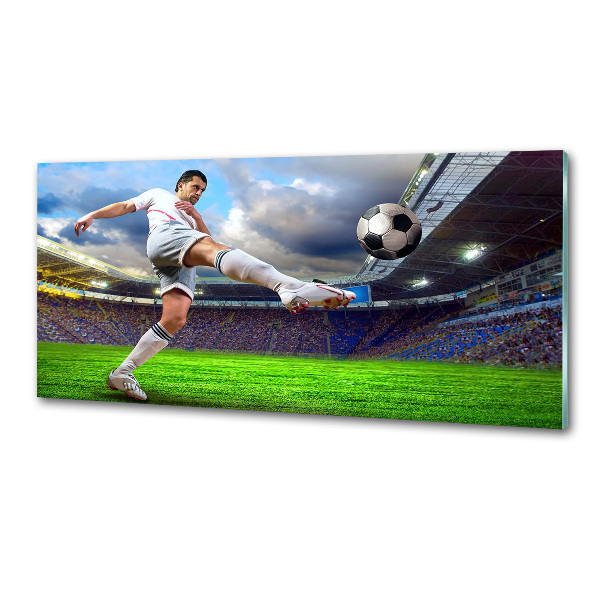 Glazen achterwand keuken Een voetballer in het stadion.