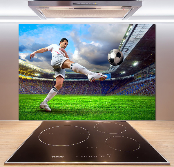 Glazen achterwand keuken Een voetballer in het stadion.