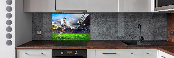 Glazen achterwand keuken Een voetballer in het stadion.