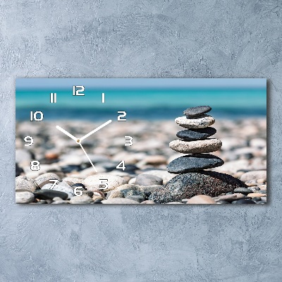 Langwerpige wandklok van glas Een stapel stenen