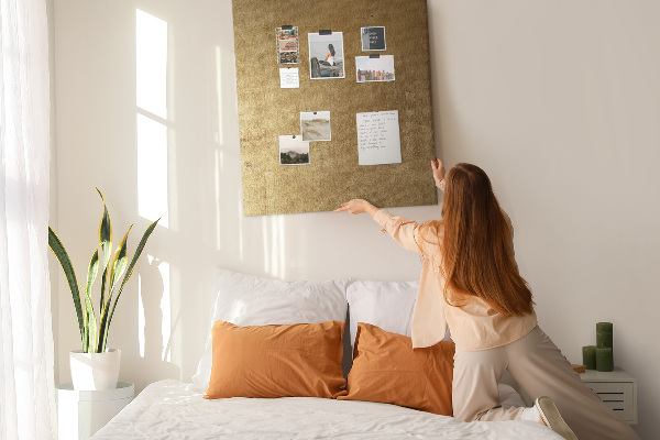 Kurk memobord met goudkleurig papier en gekleurde spelden