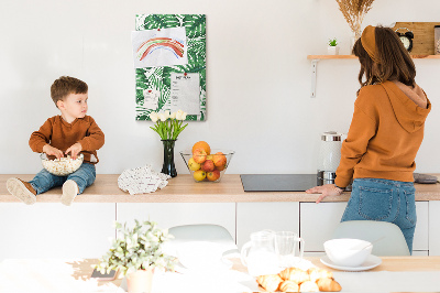 Prikbord van kurk met een print van Monstera-bladeren op een lichte achtergrond