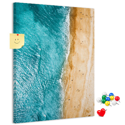 Kurken memobord met een afbeelding van een strand met golvende zee en mensen