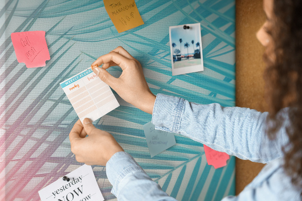 Memobord van kurk met tropische palmbladeren in pasteltinten