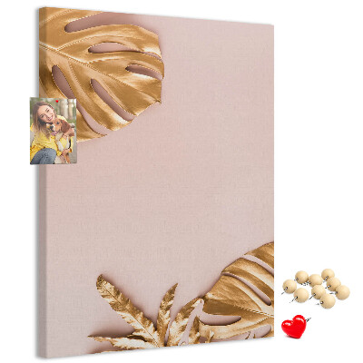 Memobord van kurk met gouden blaadjes op een zachtroze achtergrond