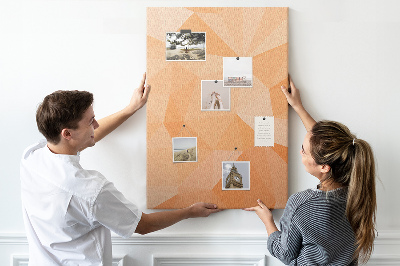 Kurk prikbord met geometrische vormen in oranje en beige tinten