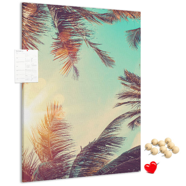 Kurken memobord met afbeelding van tropische palmbladeren in de ondergaande zon