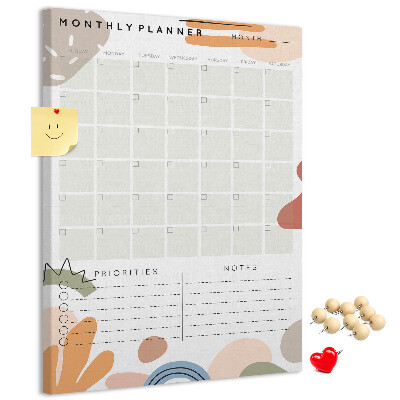 Kurken memobord maandplanner met kleurrijke abstracte vormen