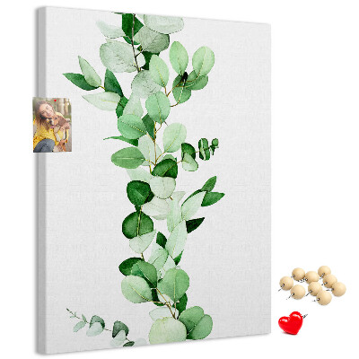 Kurken memobord met groene bladeren op een lichte achtergrond