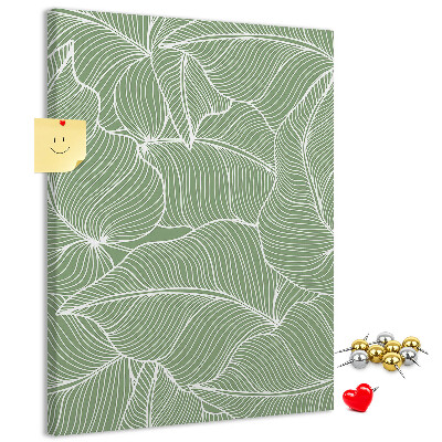 Memobord van kurk met fijne blaadjes op een groene achtergrond