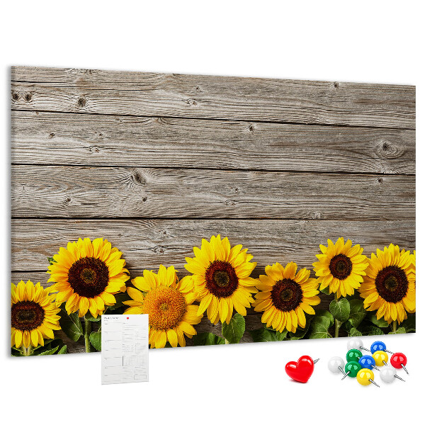 Kurkbord met een afbeelding van zonnebloemen op een achtergrond van houten planken