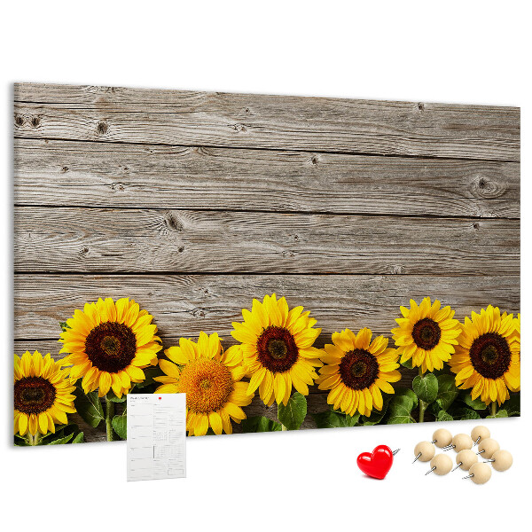 Kurkbord met een afbeelding van zonnebloemen op een achtergrond van houten planken