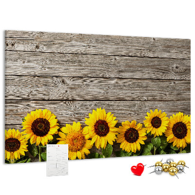 Kurkbord met een afbeelding van zonnebloemen op een achtergrond van houten planken