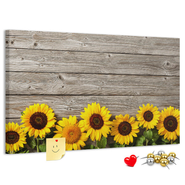 Kurkbord met een afbeelding van zonnebloemen op een achtergrond van houten planken