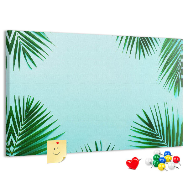 Prikbord met tropische bladeren op een blauwe achtergrond