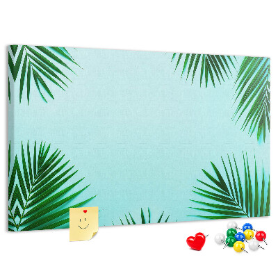 Prikbord met tropische bladeren op een blauwe achtergrond