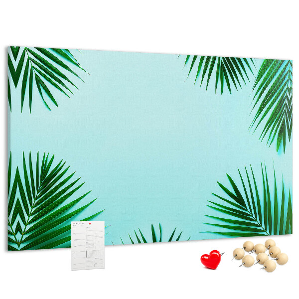 Prikbord met tropische bladeren op een blauwe achtergrond