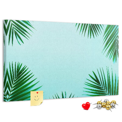 Prikbord met tropische bladeren op een blauwe achtergrond