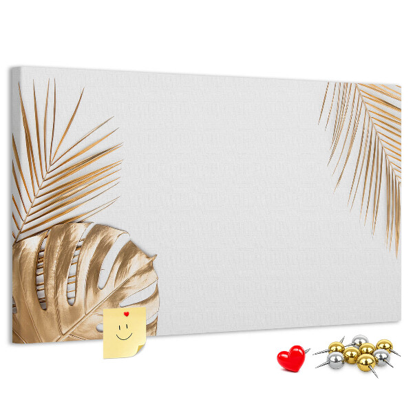 Prikbord met gouden bladeren op een witte achtergrond