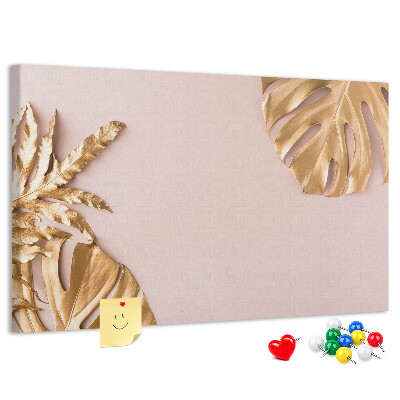 Prikbord met gouden bladeren op een delicate achtergrond