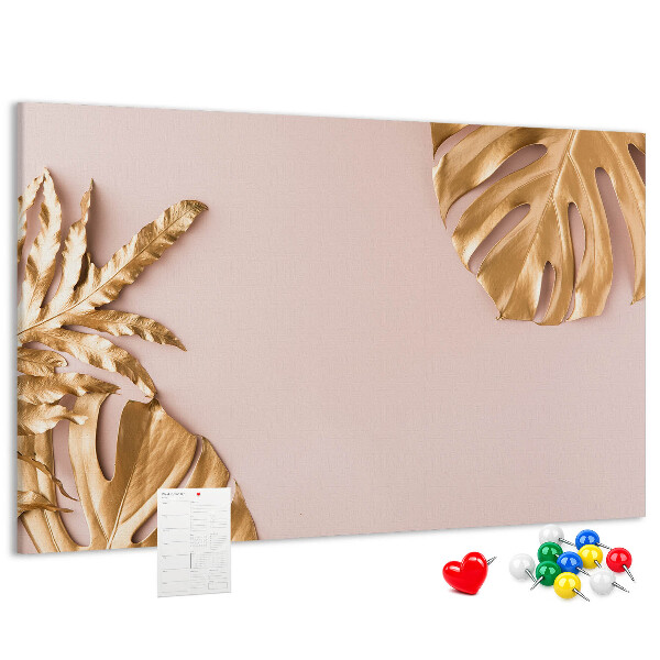 Prikbord met gouden bladeren op een delicate achtergrond