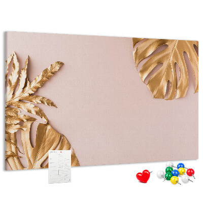 Prikbord met gouden bladeren op een delicate achtergrond