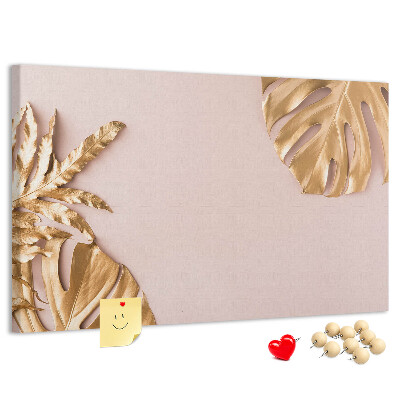 Prikbord met gouden bladeren op een delicate achtergrond