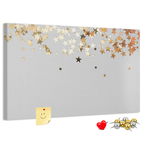 Kurkbord met gouden sterren op een grijze achtergrond