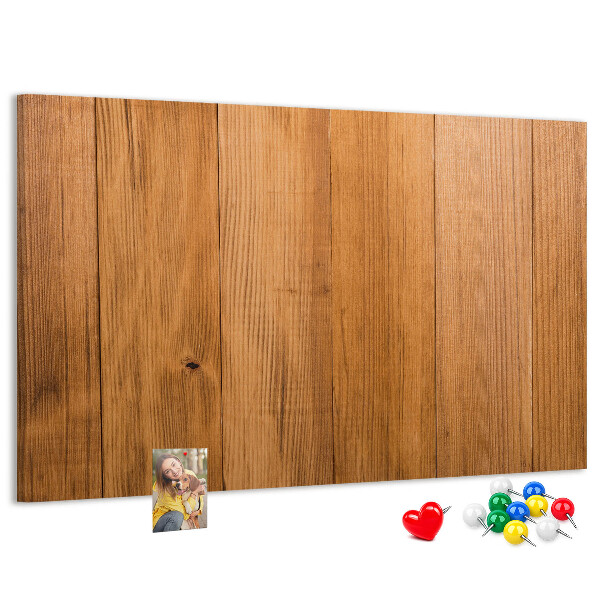 Prikbord van hout met gekleurde pinnen