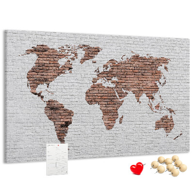 Kurkbord wereldkaart met een achtergrond van een bakstenen muur