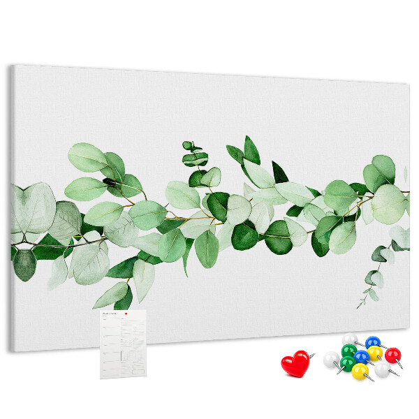 Prikbord met groene bladeren op een lichte achtergrond