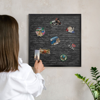 Wandbord voor magneten in een zwarte lijst Bakstenen muur